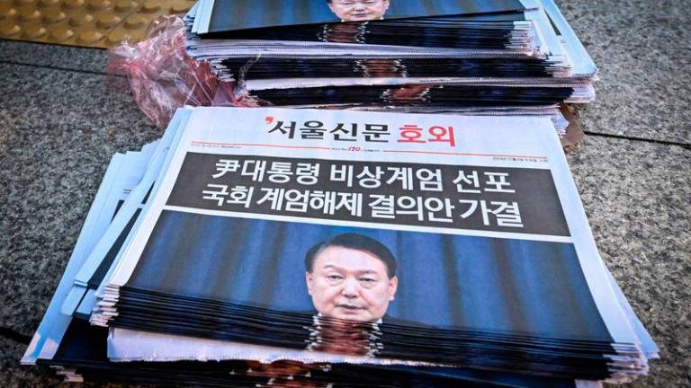 Extra edition newspapers are displayed at a subway gate in downtown Seoul - AFPpix