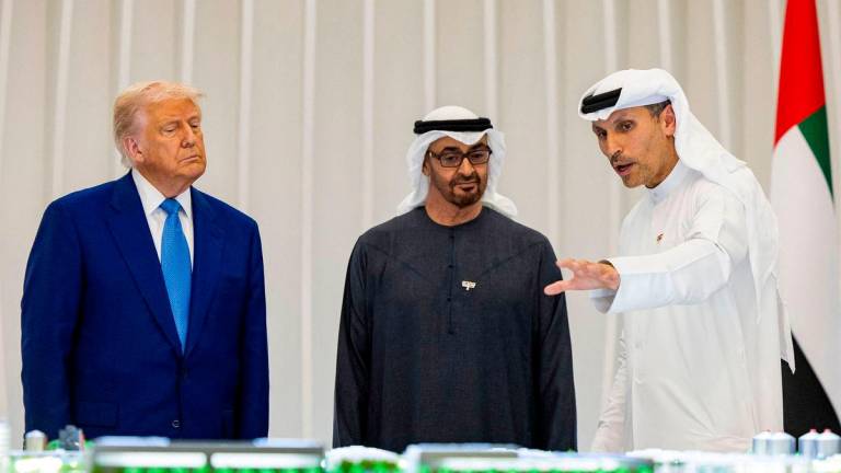 US President Donald Trump (L) and UAE President Sheikh Mohamed bin Zayed al-Nahyan (C) listen, as Mubadala CEO Khaldoon Khalifa al-Mubarak (R) speaks in front of a model of the UAE USA AI Cluster, during the launching ceremony in Abu Dhabi on May 15, 2025. The United Arab Emirates is the third leg of Trump’s visit to the region, which has already taken him to Saudi Arabia and Qatar.AFPpix
