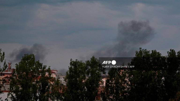 Smoke raises above the buildings following Russian air attacks in the western Ukrainian city of Lviv on August 21, 2025, amid the Russian invasion of Ukraine. - YURIY DYACHYSHYN / AFP