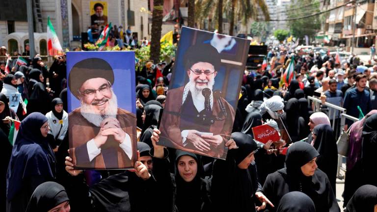 Demonstrators hold pictures of Iran’s Supreme Leader Ayatollah Ali Khamenei and late Hezbollah leader Hassan Nasrallah, as people gather for a rally in solidarity with Iran, amid the Iran-Israel conflict, in Beirut’s southern suburbs, Lebanon June 20, 2025. - REUTERS/Mohamed Azakir
