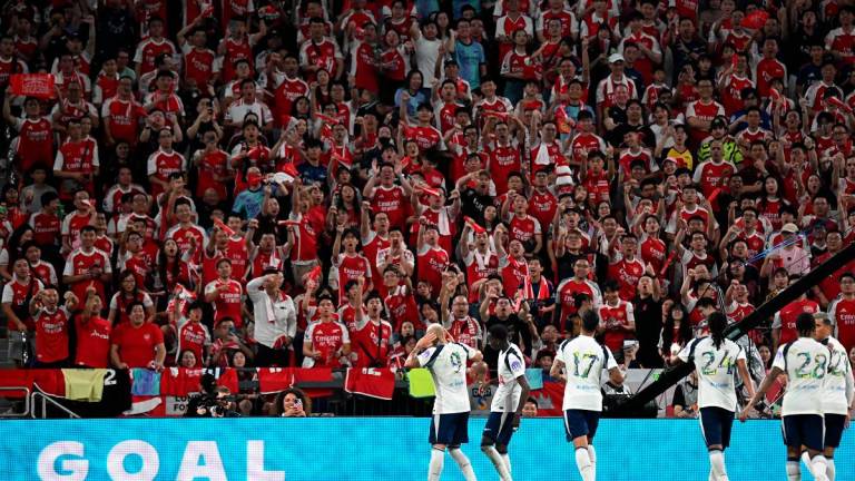 Tottenham Hotspur’s players celebrate a goal in front of Arsenal fans during their friendly exhibition football match at the Kai Tak Stadium in Hong Kong on July 31, 2025. - Peter PARKS / AFP