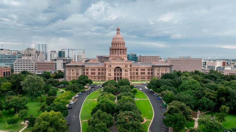 In an aerial view, the Texas Capitol is seen on August 04, 2025 in Austin, Texas. Texas Democratic lawmakers have fled the state in an attempt to protest and deny the newly proposed Republican redistricting plan. Gov. Greg Abbott has threatened to remove lawmakers who do not return by today. - Brandon Bell/Getty Images/AFPPIX