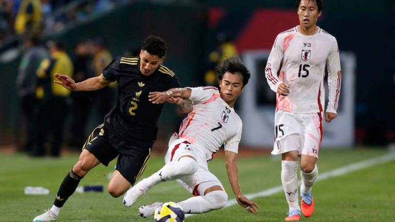 Mexico’s defender #02 Jorge Sanchez and Japan’s midfielder #07 Kaoru Mitoma fight for the ball along the sideline during the MexTour international friendly football match between Mexico and Japan. - Karl Mondon / AFP