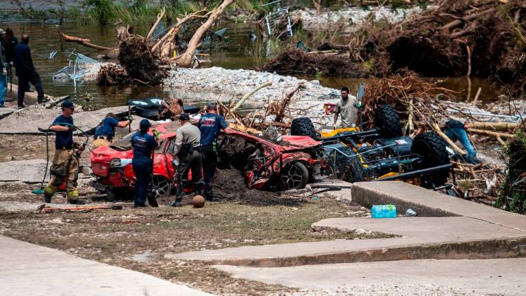 First responders attend to a vehicle pulled from the water in the aftermath of deadly flooding in Kerrville, Texas, U.S., July 6, 2025. - REUTERS/Sergio Flores