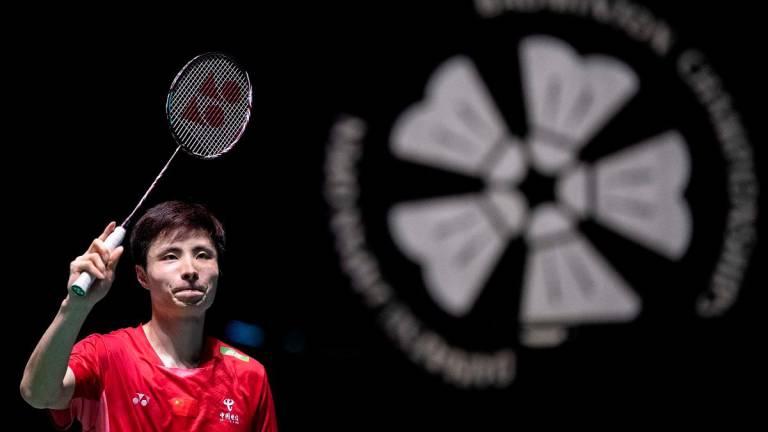 China’s Shi Yuqi celebrates his victory against France’s Alex Lanier during their men’s singles final match on the final day of the Japan Open badminton tournament at Tokyo Gymnasium in Tokyo on July 20, 2025. - Yuichi YAMAZAKI / AFP