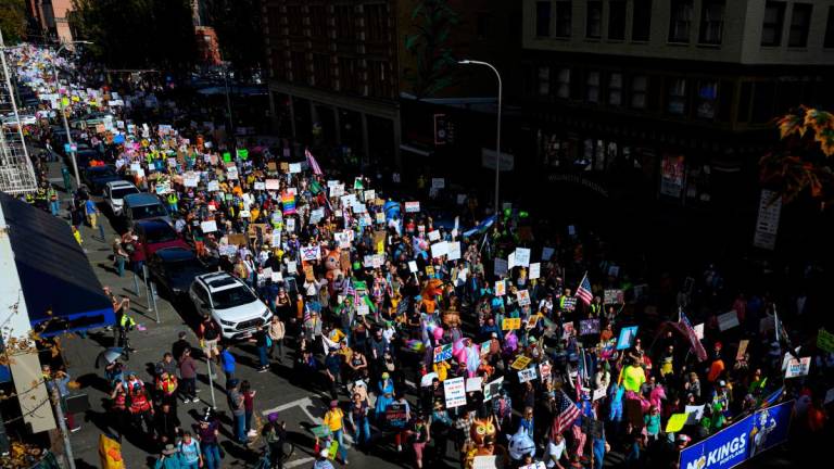 Demonstrators march through downtown Portland during the “No Kings” protest on October 18, 2025 in Portland, Oregon. - Mathieu Lewis-Rolland/Getty Images/AFP