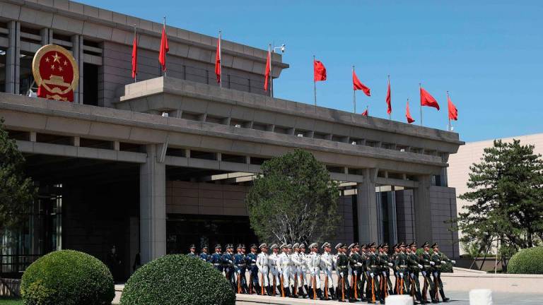 Members of a Chinese honour guard march to the tarmac as they prepare to welcome Zimbabwe’s President Emmerson Mnangagwa at Beijing Capital International Airport in Beijing on September 1, 2025, ahead of a military parade in the capital on September 3 to mark 80 years since the end of World War II. - Lintao Zhang / POOL / AFP