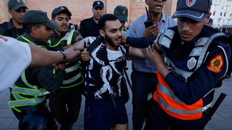 Members of the security forces detain a protester during a youth-led demonstration in Rabat on September 29, 2025, calling for reforms in the public health and education sectors. - Majid BZIOUAT / AFP