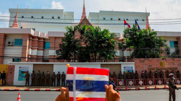 FILE PHOTO: A royalist activist holds a Thai flag as he protests in front of the Royal Embassy of Cambodia, following a recent clash at the Thailand-Cambodia border on May 28, 2025, in Bangkok, Thailand, June 6, 2025. REUTERS