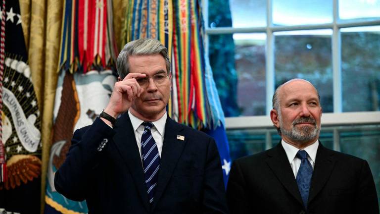 US Treasury Secretary Scott Bessent (L) and Commerce Secretary Howard Lutnick listen to President Donald Trump speak in the Oval Office of the White House in Washington, DC, on August 6, 2025 to announce Apple will invest an additional $100 billion in the United States, taking its total pledge to $600 billion over the next four years. - AFPPIX