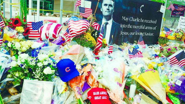 Flowers, photos and other items lie at a memorial for Kirk at the Turning Point USA headquarters in Phoenix, Arizona, US on Sept 12. – REUTERSPIC