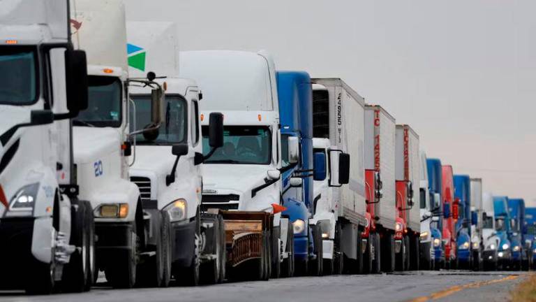 Trucks wait in line to cross into the United States near the border customs control at the World Trade Bridge, in Nuevo Laredo, Mexico - REUTERSpix