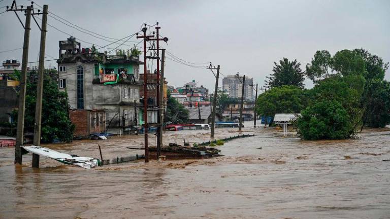 A general view shows houses submerged in flood waters after the Bagmati river overflowed during monsoon rains in Kathmandu on September 28, 2024. Floods and landslides caused by heavy downpours in Nepal killed at least 10 people across the Himalayan country, with rescue teams searching for 18 missing, a disaster official said on September 28. - PRAKASH MATHEMA / AFP