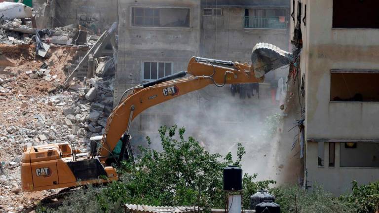 (FILES) An Israeli military bulldozer demolishes a home at the Nur Shams Palestinian refugee camp, east of Tulkarem, in the Israeli occupied West Bank on June 23, 2025, during an ongoing military operation in the north of the Palestinian West Bank. - AFPpix