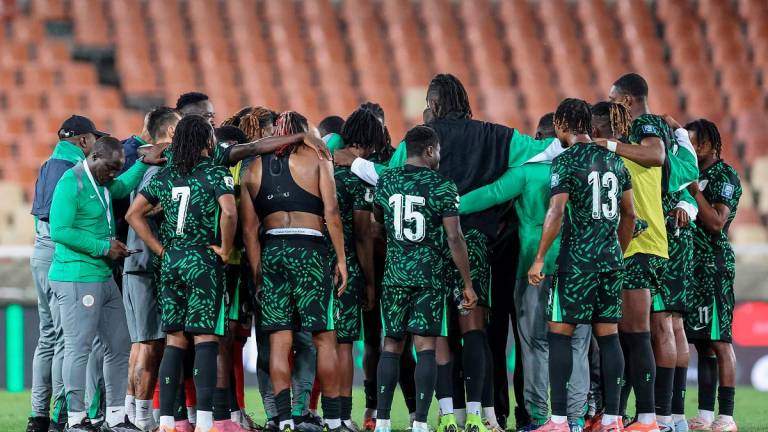 Nigeria’s players gather in a huddle after the FIFA World Cup 2026 Africa qualifiers group C match between Lesotho and Nigeria at the Peter Mokaba Stadium in Polokwane on October 10, 2025. - PHILL MAGAKOE / AFP