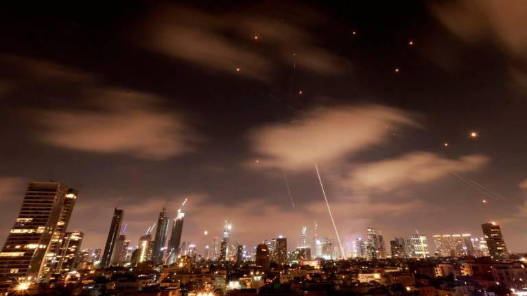Israeli air defence systems are activated to intercept Iranian missiles over the Israeli city of Tel Aviv early on June 18, 2025. Israel and Iran exchanged fire again on June 17, the fifth day of strikes in their most intense confrontation in history, fuelling fears of a drawn-out conflict that could engulf the Middle East. - Menahem Kahana / AFP