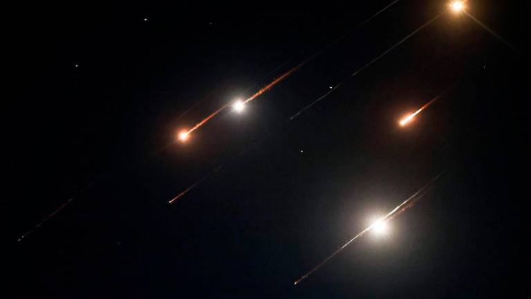 Missiles fired from Iran are pictured in the night sky over Nablus in the occupied West Bank on June 14, 2025. Israel and Iran exchanged fire on June 14, a day after Israel unleashed an unprecedented aerial bombing campaign that Iran said hit its nuclear facilities, “martyred” top commanders and killed dozens of civilians. AFPpix