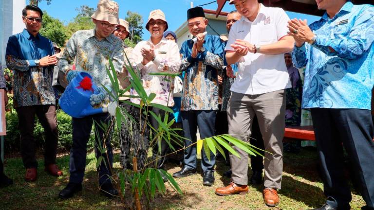 Chan (second, left) watering a bamboo plant to mark the opening of World Bamboo Day Malaysia 2025 at the Bamboo Model Farm, Terengganu Timber Industry Training Centre in Kuala Berang. – Bernamapic