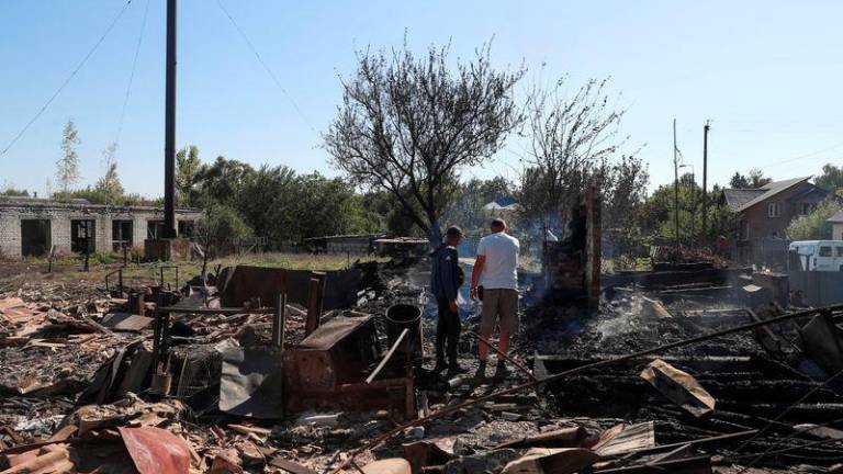 Residents stand at a site of a building destroyed by a Russian military strike, amid Russia's attack on Ukraine, in the village of Yampil, in Sumy region, Ukraine September 6, 2024. - REUTERSPIX