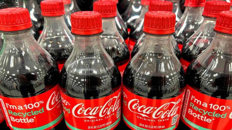 (FILES) Plastic bottles that read “100% Recycled Bottle” of Coca-Cola sit on the shelf at a store in Stevensville, Maryland, on March 25, 2025. Beverage giant Coca-Cola has agreed to use real cane sugar in its US production, President Donald Trump announced on July 16, 2025 on social media. Coca-Cola did not immediately confirm the ingredient shift- Photo by Jim WATSON / AFP