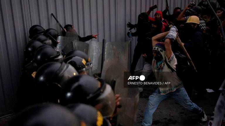 Protesters clash with riot police during an anti-government demonstration in Lima on September 20, 2025. - AFP