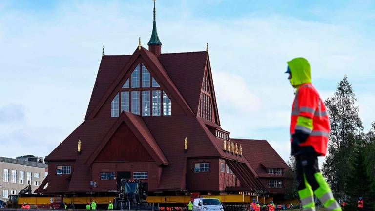 Workers prepare the moving of the wooden Kiruna Church, in Kiruna, Sweden on August 19, 2025. The church is being moved five kilometers to the new center of Kiruna due to the expansion of the iron ore mine. - Jonathan Nackstrand / AFP