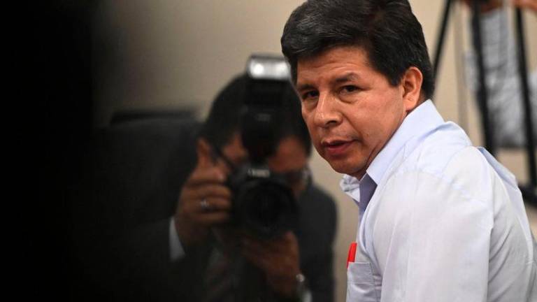 Peru’s former president (2021-2022) Pedro Castillo gestures on arrival for the opening hearing of the oral trial against him and three former ministers of his government, at the courtroom of the National Police Special Operations Directorate (DINOES) in Lima on March 4, 2025.. AFP pix