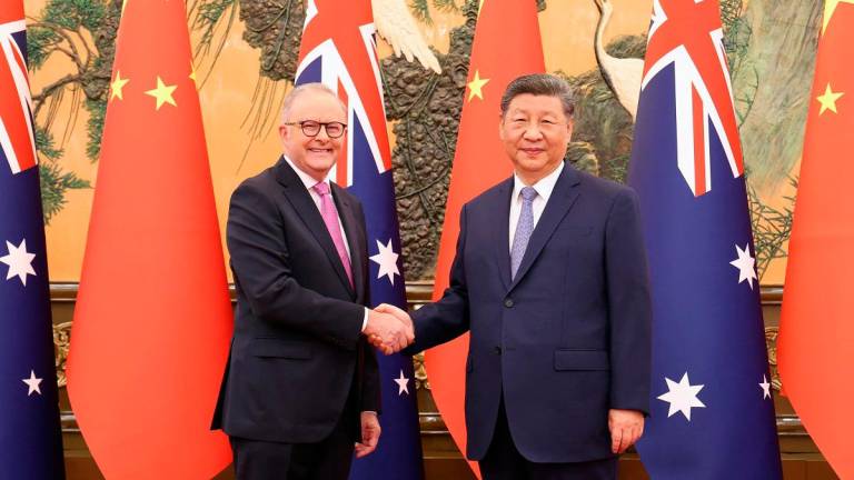 Chinese President Xi Jinping and Australian Prime Minister Anthony Albanese shake hands at the Great Hall of the People in Beijing, China July 15, 2025. - China Daily via REUTERS