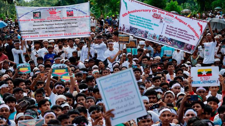 Rohingya refugees hold banners and placards while taking part in a protest rally inside a refugee camp to mark the eight-year anniversary of their exodus, in Cox’s Bazar, Bangladesh, August 25, 2025. REUTERS/Mohammad Ponir Hossain
