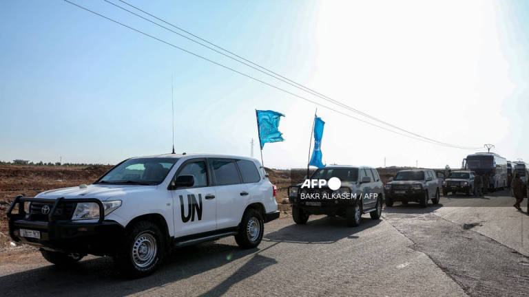 A United Nations convoy evacuating families from Sweida moves through the buffer zone in Busra al-Harir in Syria's southern Daraa province on July 22, 2025. - AFP