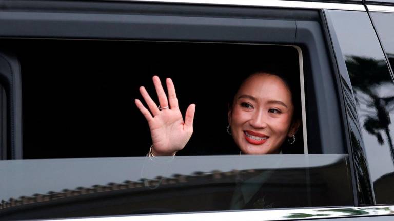 Thailand’s Paetongtarn Shinawatra, who was dismissed as prime minister, leaves following a press conference after the Constitutional Court ruled to remove her from office in a high-profile ethics case, following a leaked phone conversation between her and Cambodia’s former leader Hun Sen, at Government House in Bangkok, Thailand, August 29, 2025. REUTERS/Chalinee Thirasupa