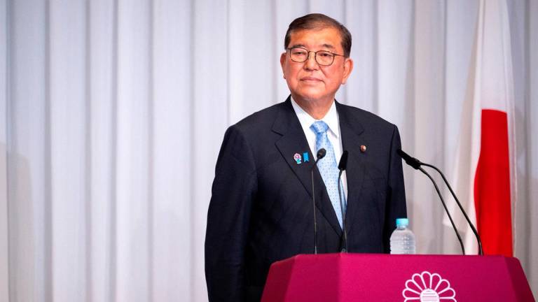 Japan's Prime Minister Shigeru Ishiba attends a press conference at the headquarters of the Liberal Democratic Party (LDP) in Tokyo on July 21, 2025, the day after the prime minister's coalition lost its upper house majority. - PHILIP FONG/Pool via REUTERS