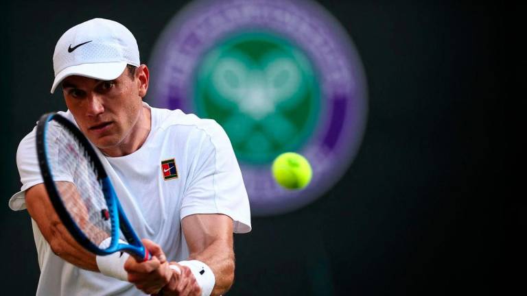 Britain’s Jack Draper returns the ball to Argentina’s Sebastian Baez during their men’s singles first round tennis match on the second day of the 2025 Wimbledon Championships at The All England Lawn Tennis and Croquet Club in Wimbledon, southwest London, on July 1, 2025- AFP