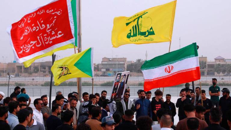 Supporters of Iraq’s Hezbollah Brigades attend a gathering to condemn Israel’s attack on Iran in the city of Nasiriyah. AFP