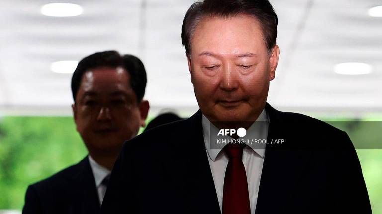 South Korea's former impeached president Yoon Suk Yeol (R) arrives at a court to attend a hearing to review his arrest warrant requested by special prosecutors in Seoul on July 9, 2025. South Korean prosecutors requested a new arrest warrant on July 6 to detain former president Yoon Suk Yeol, after questioning him twice, including a session that lasted over nine hours. - KIM HONG-JI / POOL / AFP