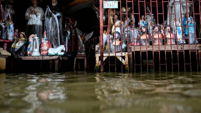 For visual purposes only: Religious statues made of resin are displayed at a flooded shop, intensified by rain caused by Severe Tropical Storm Matmo, in San Roque, Macabebe, Pampanga, Philippines, October 4, 2025. REUTERS/Noel Celis
