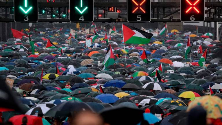 Demonstrators march across the Sydney Harbour Bridge during a pro-Palestinian rally against Israel's actions and the ongoing food shortages in the Gaza Strip, in Sydney on August 3, 2025. - DAVID GRAY / AFP