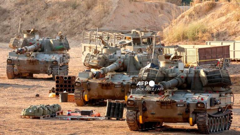 This picture taken from a position at Israel’s border with the Gaza Strip shows Israeli mobile artillery units deployed near the border fence with the besieged Palestinian territory on September 17, 2025. - Jack GUEZ / AFP