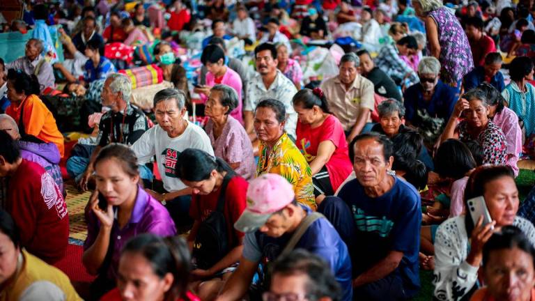 People rest inside a temporary shelter in Srisaket province, after Thailand and Cambodia exchanged heavy artillery fire for a second day on Friday as border fighting intensified and spread, while Cambodia's leader said Thailand had agreed to a Malaysian ceasefire proposal but then backed down, Thailand, July 26, 2025. - REUTERSPIX