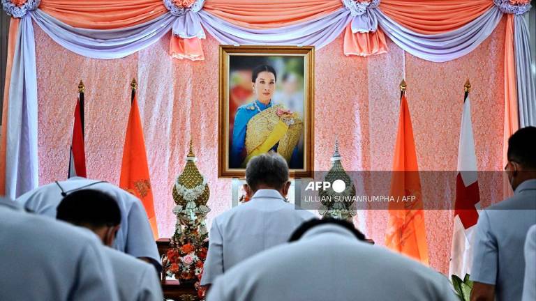 (Files) Well-wishers bow in front of an image of Thailand's Princess Bajrakitiyabha Mahidol, at Chulalongkorn Hospital in Bangkok on December 16, 2022. - Lillian SUWANRUMPHA / AFP