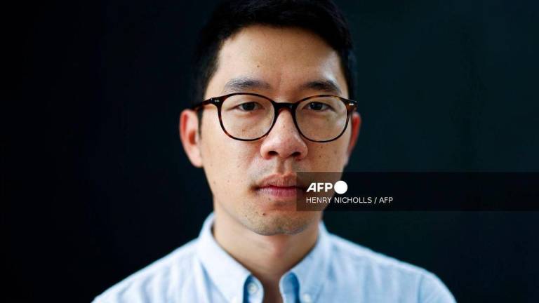 (FILES) In this picture taken on August 18, 2023, former Hong Kong legislator and pro-democracy activist Nathan Law poses for a photograph in London. (Photo by HENRY NICHOLLS / AFP)