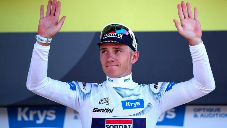 Soudal Quick-Step team's Belgian rider Remco Evenepoel celebrates on the podium with the best young rider's white jersey after the 13th stage of the 112th edition of the Tour de France cycling race, 10.9 km individual time trial between Loudenvielle and Peyragudes, in the Pyrenees mountains of southwestern France, on July 18, 2025. - AFPPIX