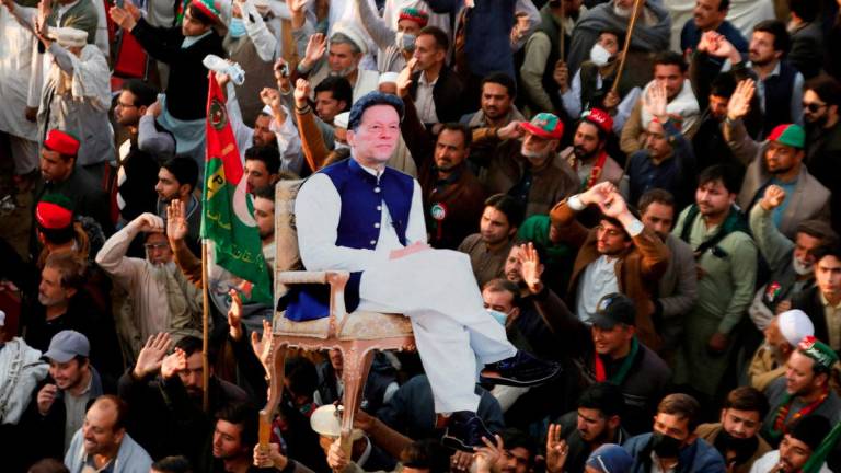 Supporters of the former Pakistani Prime Minister Imran Khan's party, the Pakistan Tehreek-e-Insaf (PTI), carry a cutout of him, as they gather, to protest what they call a black day and a stolen mandate in last year's general election, during a rally in Swabi, Pakistan February 8, 2025. - REUTERSPIX