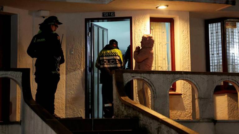Neighbors of a house adjacent to the place where Venezuelan human rights activist Yendri Velasquez and political consultant Luis Peche were shot and injured, are escorted by police, in Bogota, Colombia, October 13, 2025. - REUTERSPIX