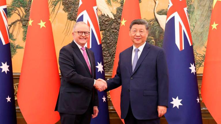 Chinese President Xi Jinping and Australian Prime Minister Anthony Albanese shake hands at the Great Hall of the People in Beijing - China Daily via REUTERSPix