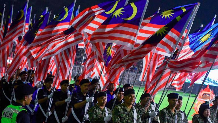 The parade of the contingent carrying the Jalur Gemilang during the Eve of National Day 2025 Celebration at the Kelantan state level, held at Sultan Muhammad IV Stadium last night. – BERNAMA