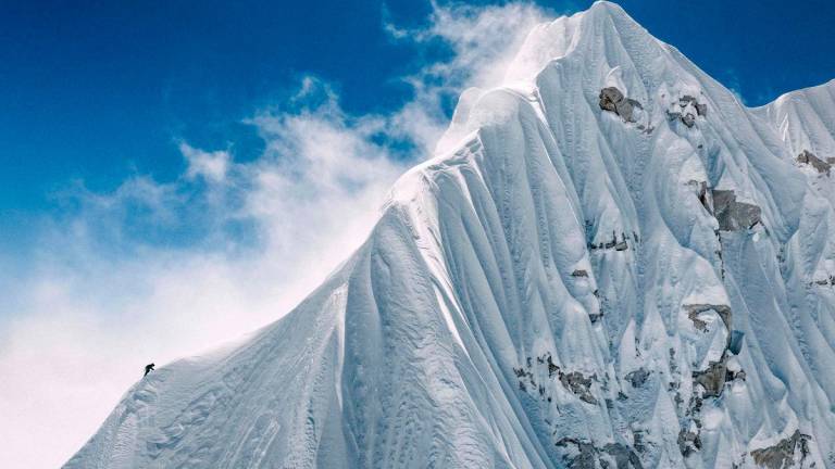 In this handout photograph taken on October 15, 2025, a French mountaineer makes his way near the summit of Jannu East, the first ascent of the 7,468 m peak in eastern Nepal. - Thibaut MAROT / AFP