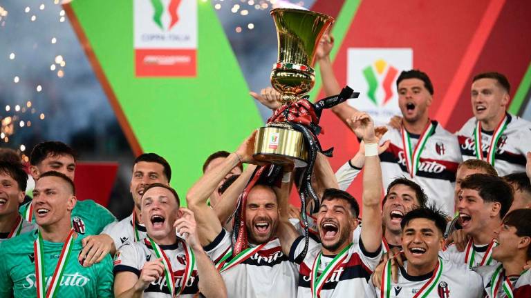 Bologna’s Italian defender #29 Lorenzo Desilvestri and Bologna’s Italian forward #07 Riccardo Orsolini hold the trophy to celebrate after winning the Italian Cup Final (Coppa Italia) final football match between AC Milan and Bologna at the Olympic stadium in Rome. AFPpix