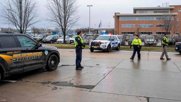 Law enforcement stand near a health care clinic where students from Abundant Life Christian School will be reunited withe their parents after a school shooting on December 16, 2024 in Madison, Wisconsin. AFPpix