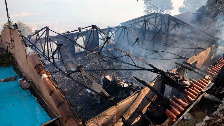 This photographs shows a burnt out building in the aftermouth of a wildfire in the L’Estaque district of Marseille - AFPPix